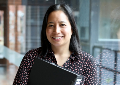 Woman in office with a folder in her hands