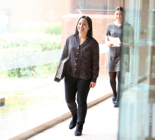 A professional woman walking through an office